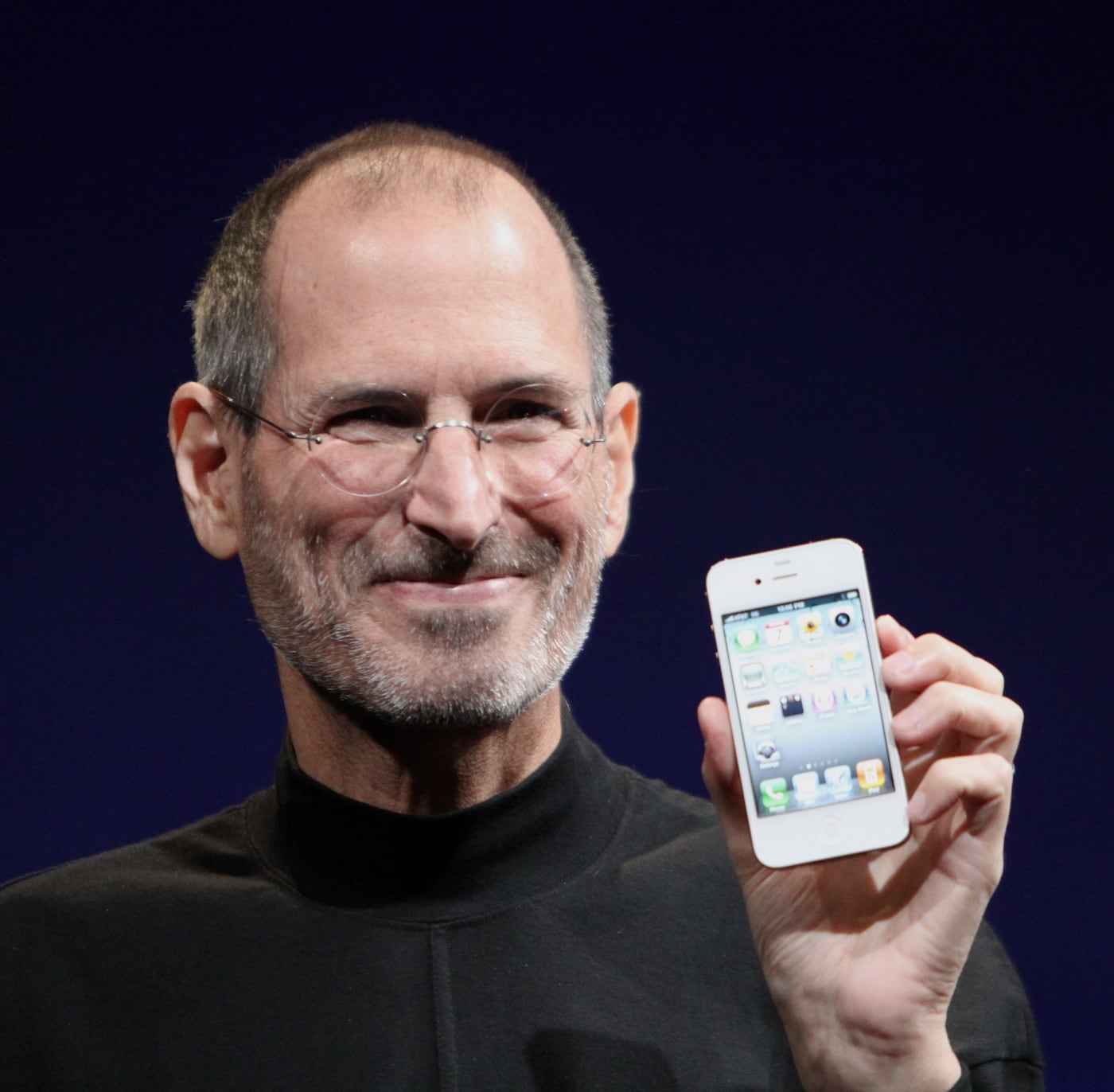 Steve Jobs holding a phone